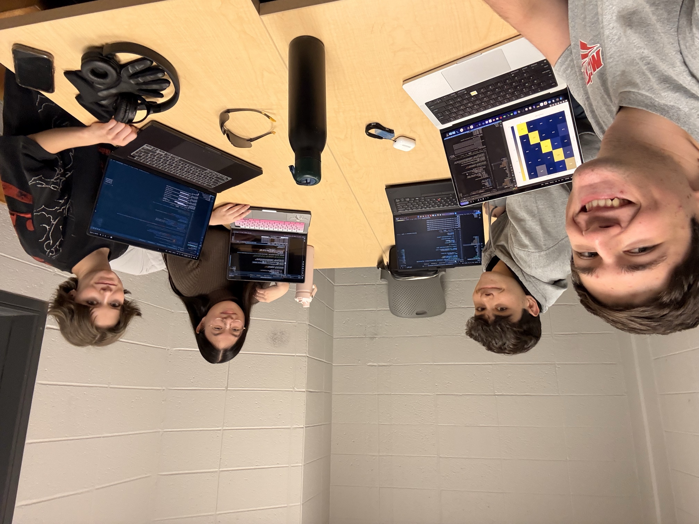 Gavin and friends coding together around a study-room table
