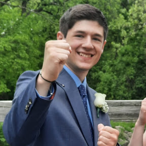 Gavin dressed up and smiling outdoors