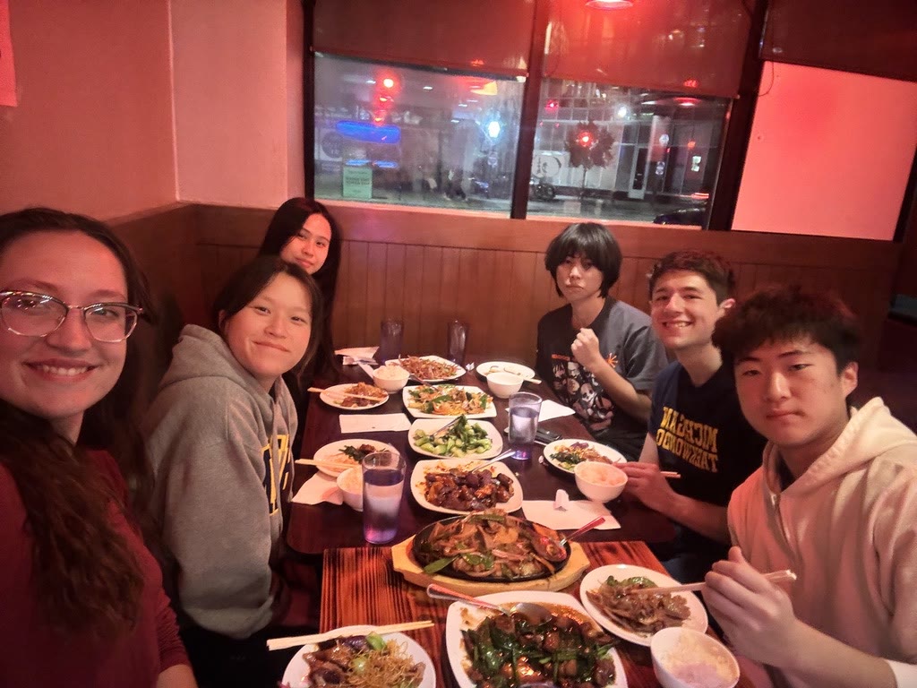 Michigan Taekwondo teammates sharing dinner around a table