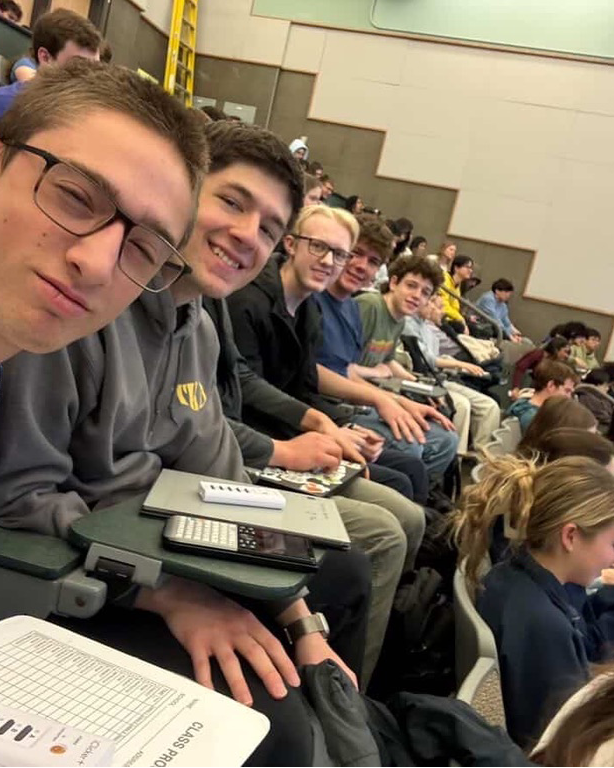 Friends sitting together in a physics lecture